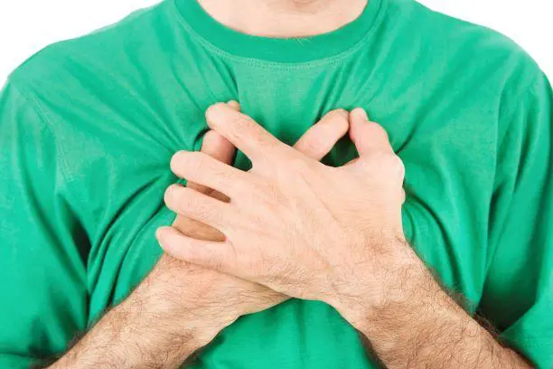 Person clutching chest in pain