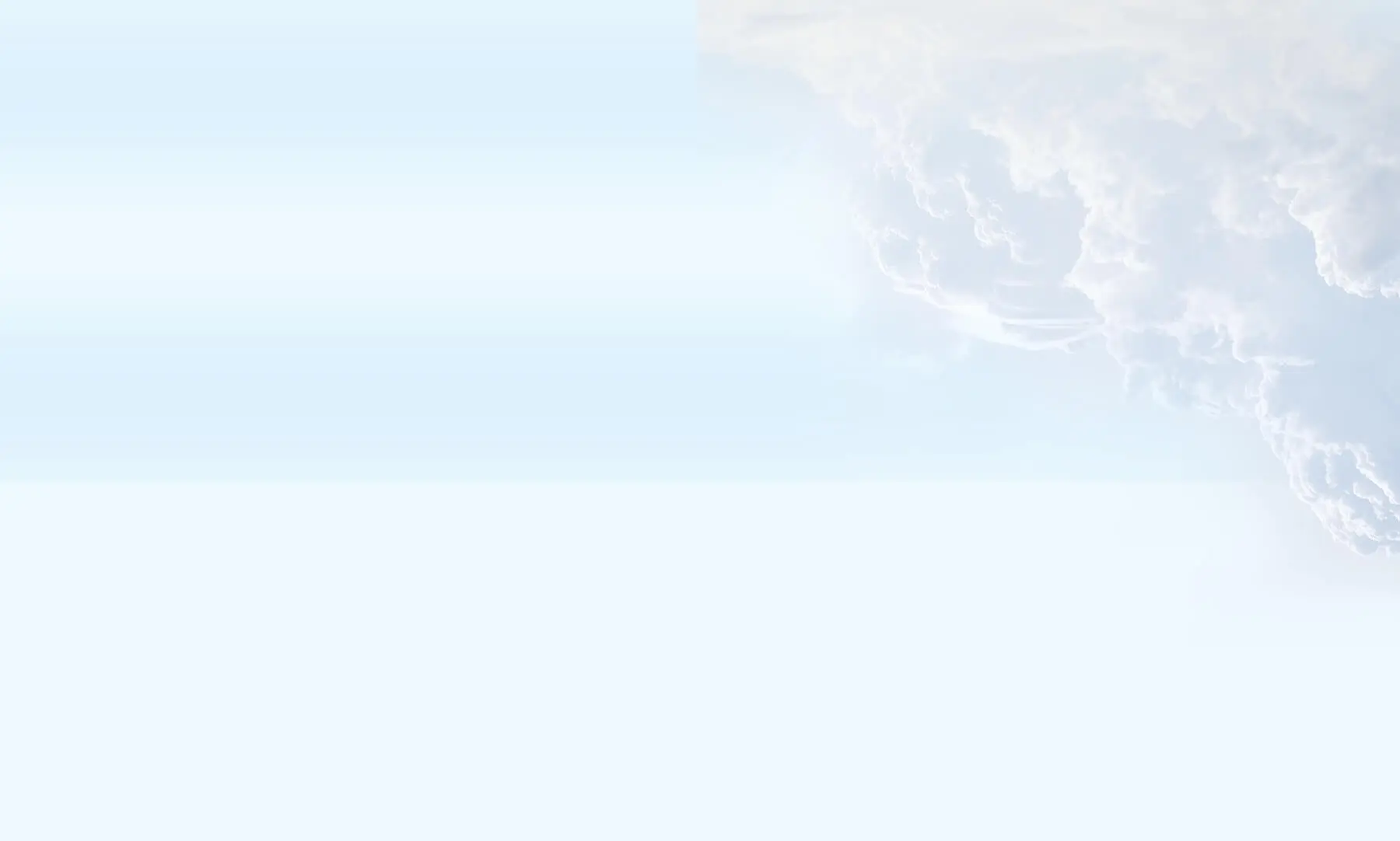 Light blue sky with soft white clouds