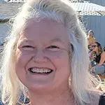 Smiling woman with long light hair outdoors