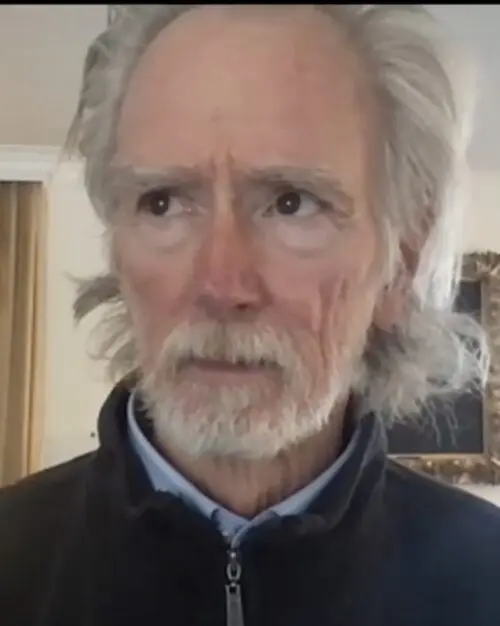 Older person with white hair and beard
