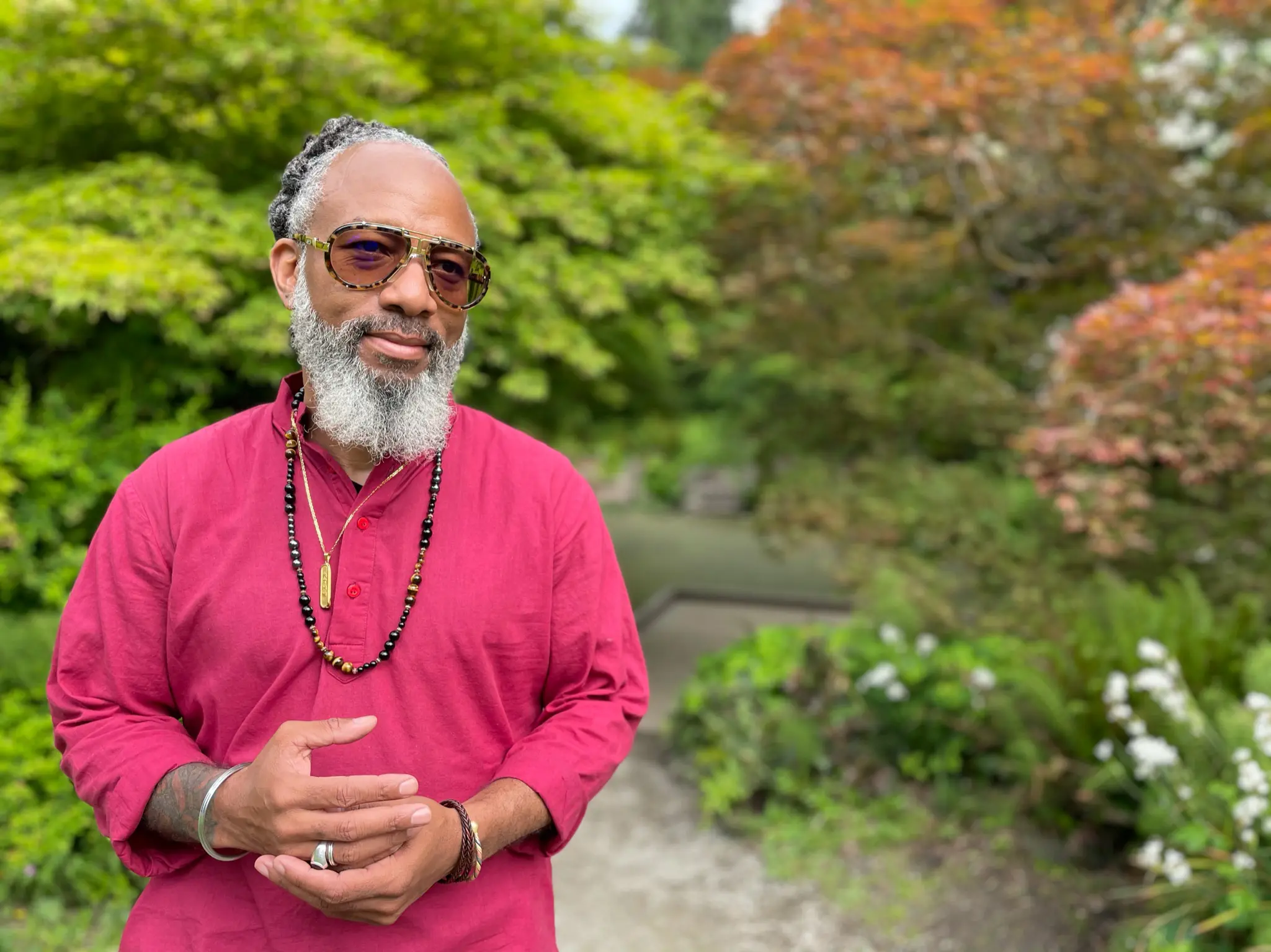Bearded person with sunglasses in garden