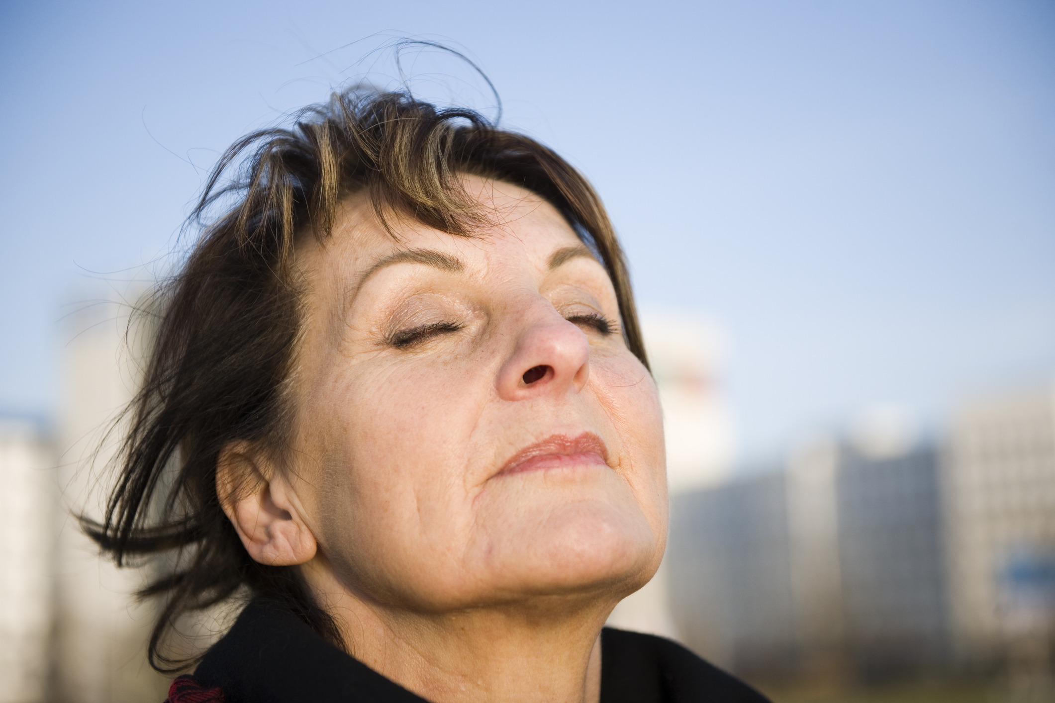 Woman practising nasal breathing outdoors, a core technique of the Buteyko Method